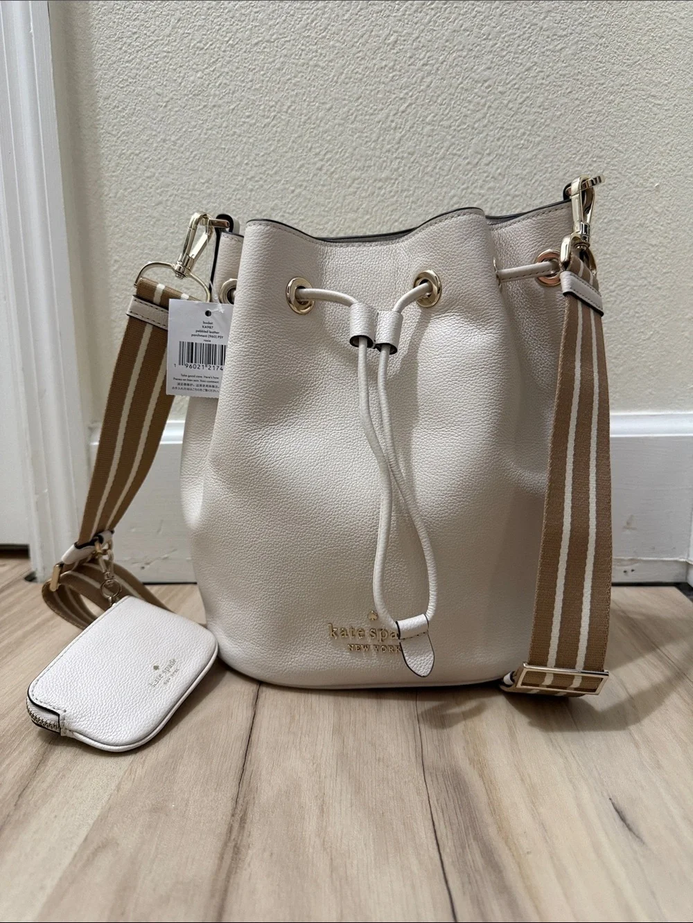 kate spade cream pebble leather drawstring bucket bag with striped tan strap